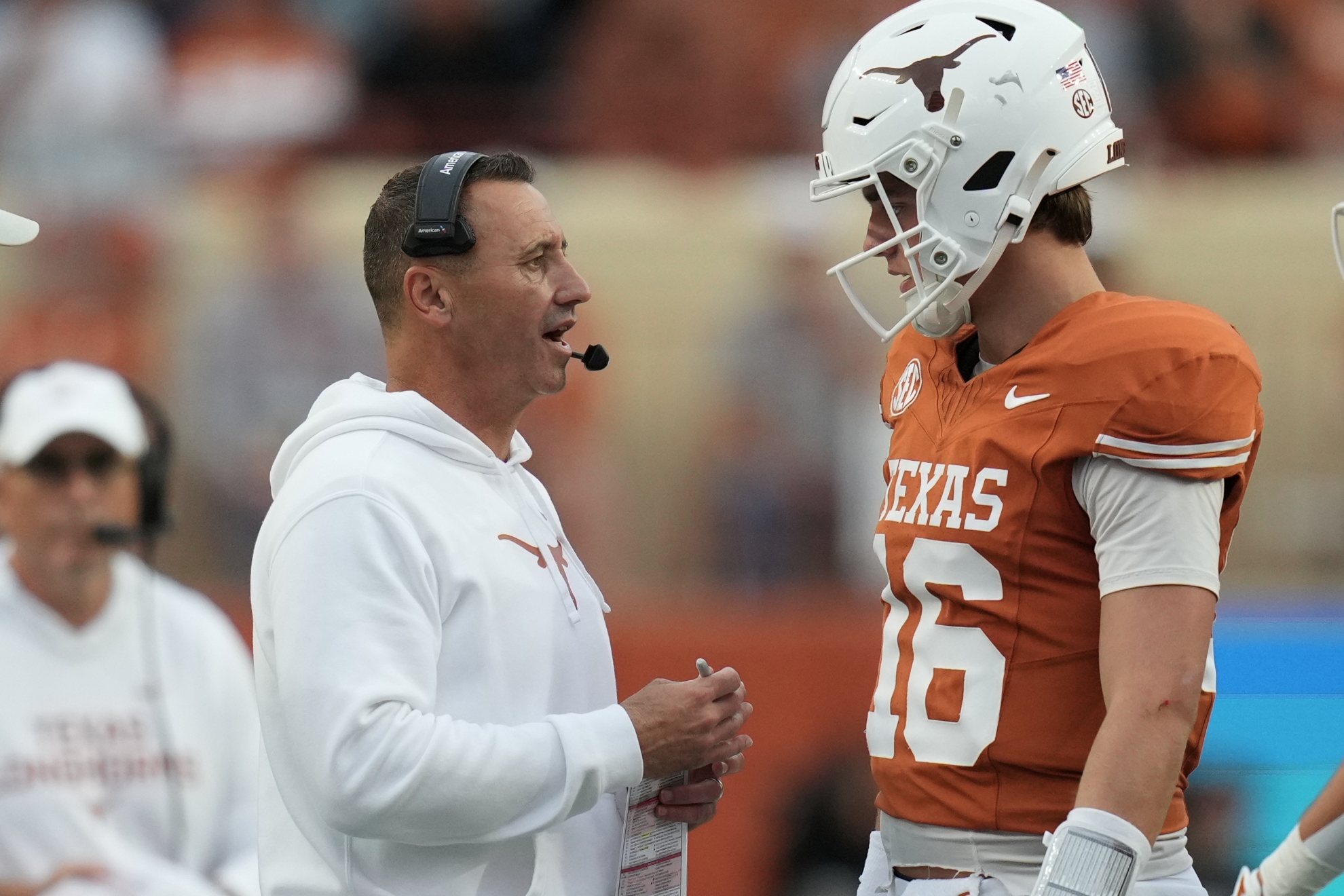Texas head coach Steve Sarkisian, left, talks with quarterback Arch Manning (16)