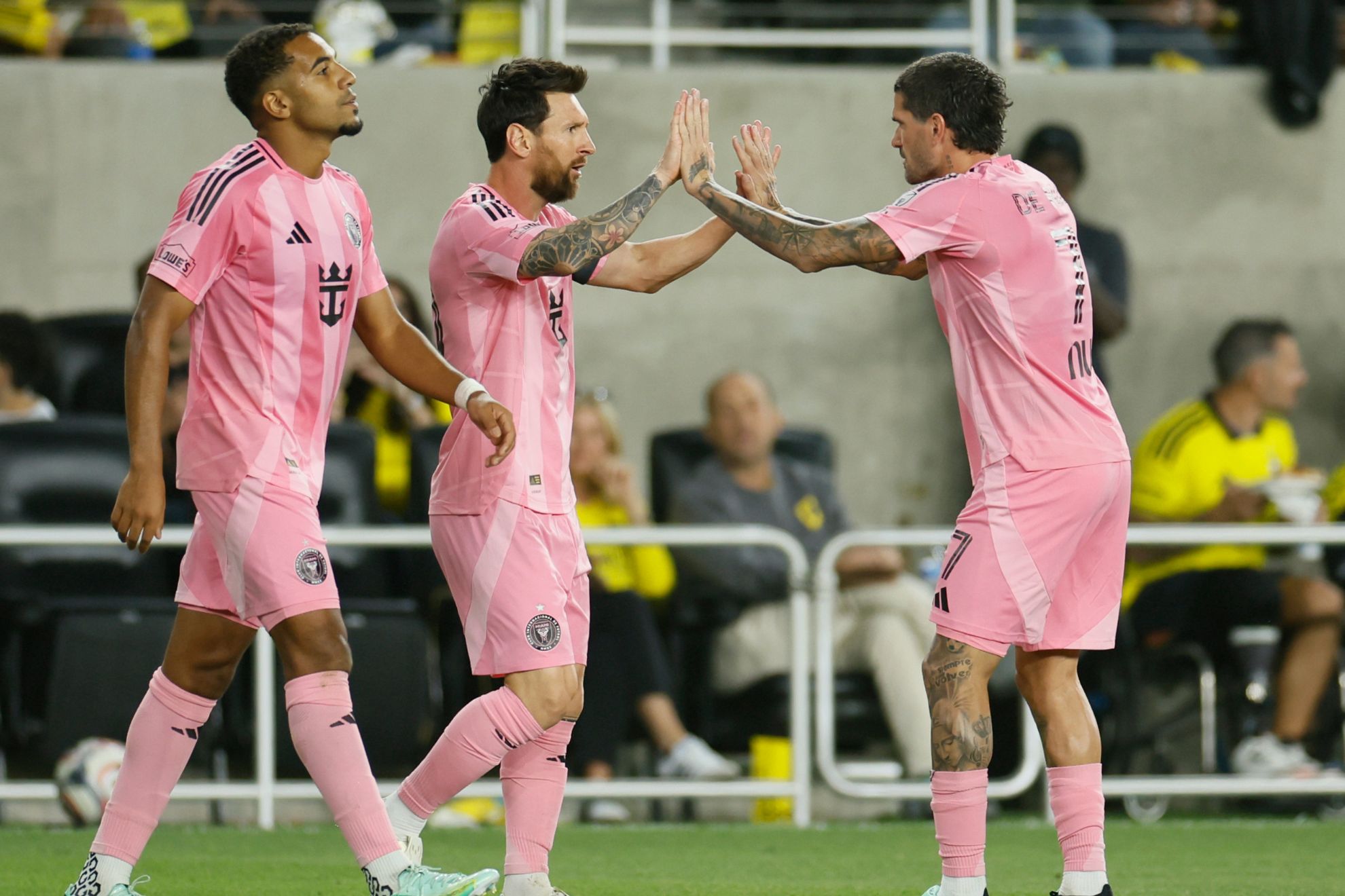 Inter Miami's Lionel Messi, center, celebrates with teammate Rodrigo De Paul