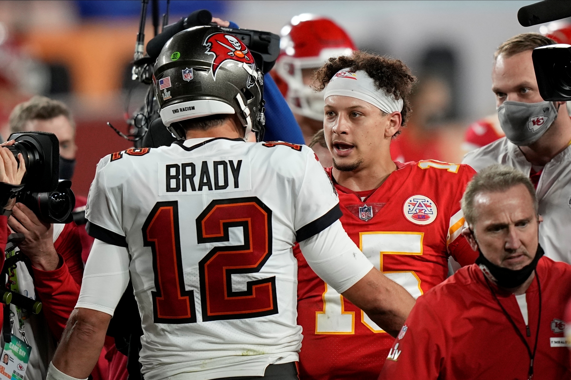 Former Tampa Bay Buccaneers quarterback Tom Brady, speaks with Kansas City Chiefs quarterback Patrick Mahomes after the NFL Super Bowl 55