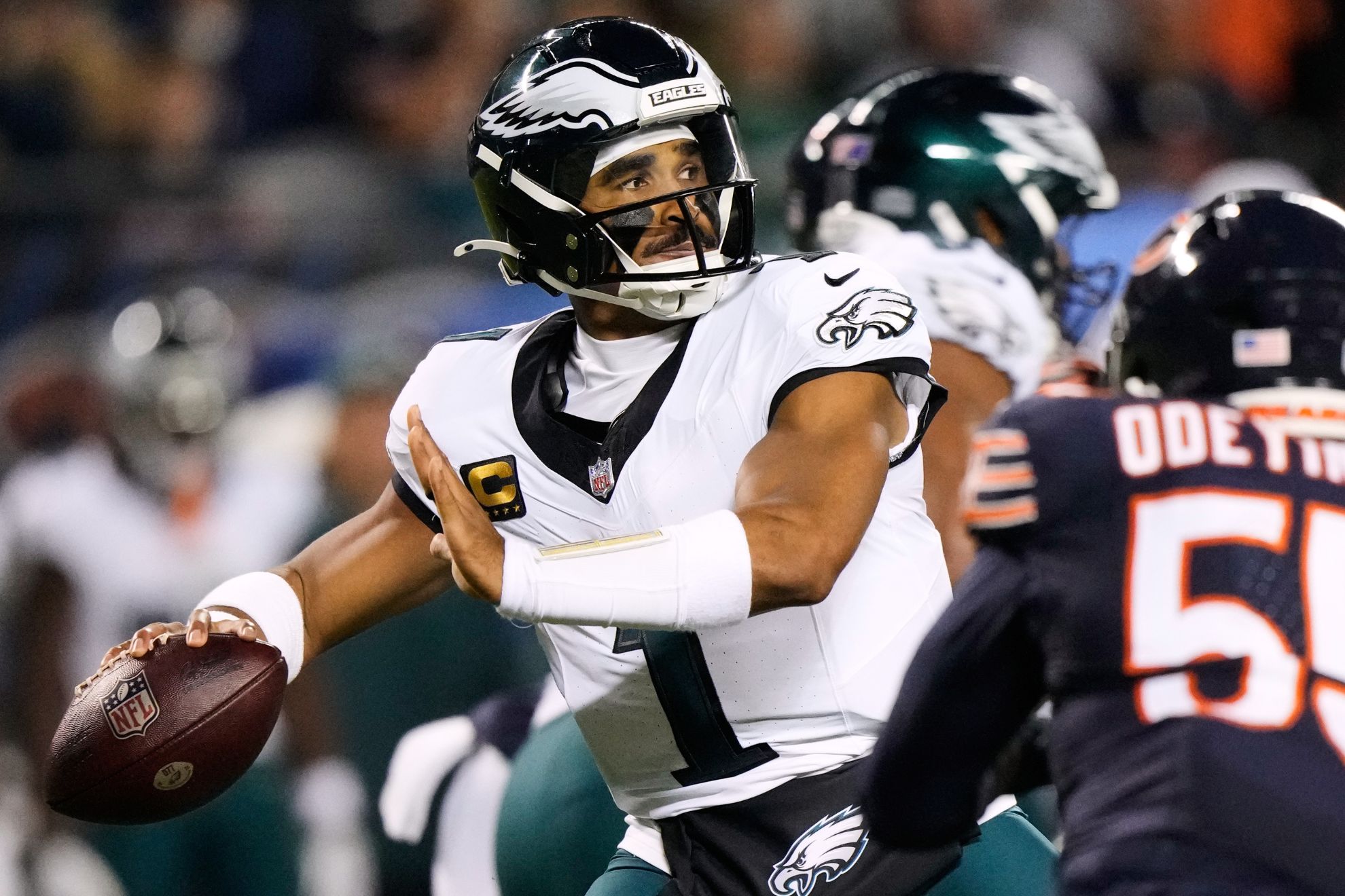 Philadelphia Eagles quarterback Jalen Hurts (1) throws a pass under pressure from Chicago Bears defensive end Dayo Odeyingbo