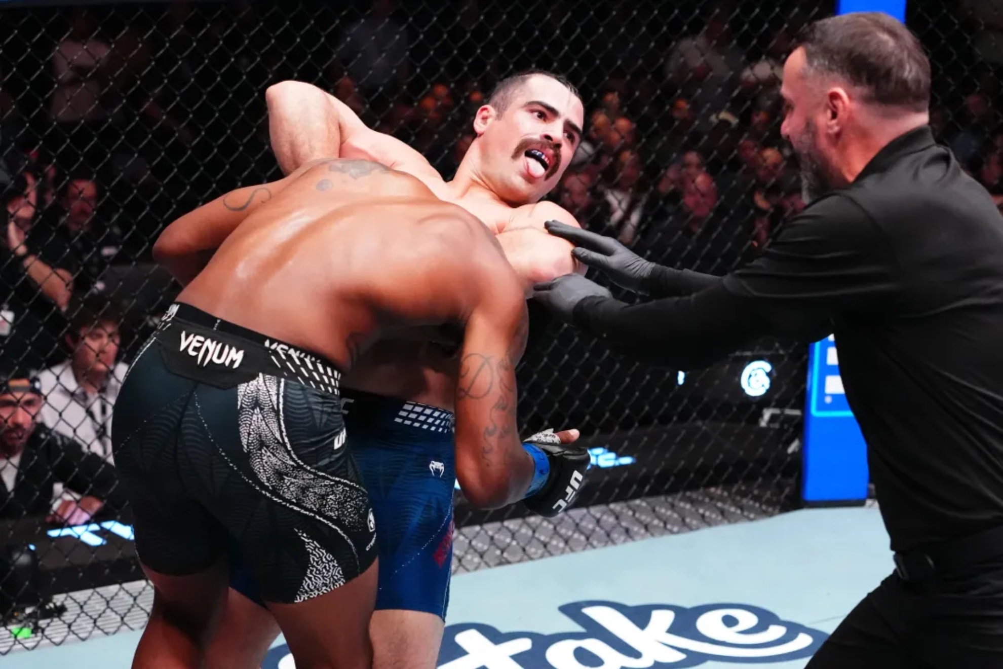 Luis Hernandez pinning Sedriques Dumas in the presence of the referee. MMA