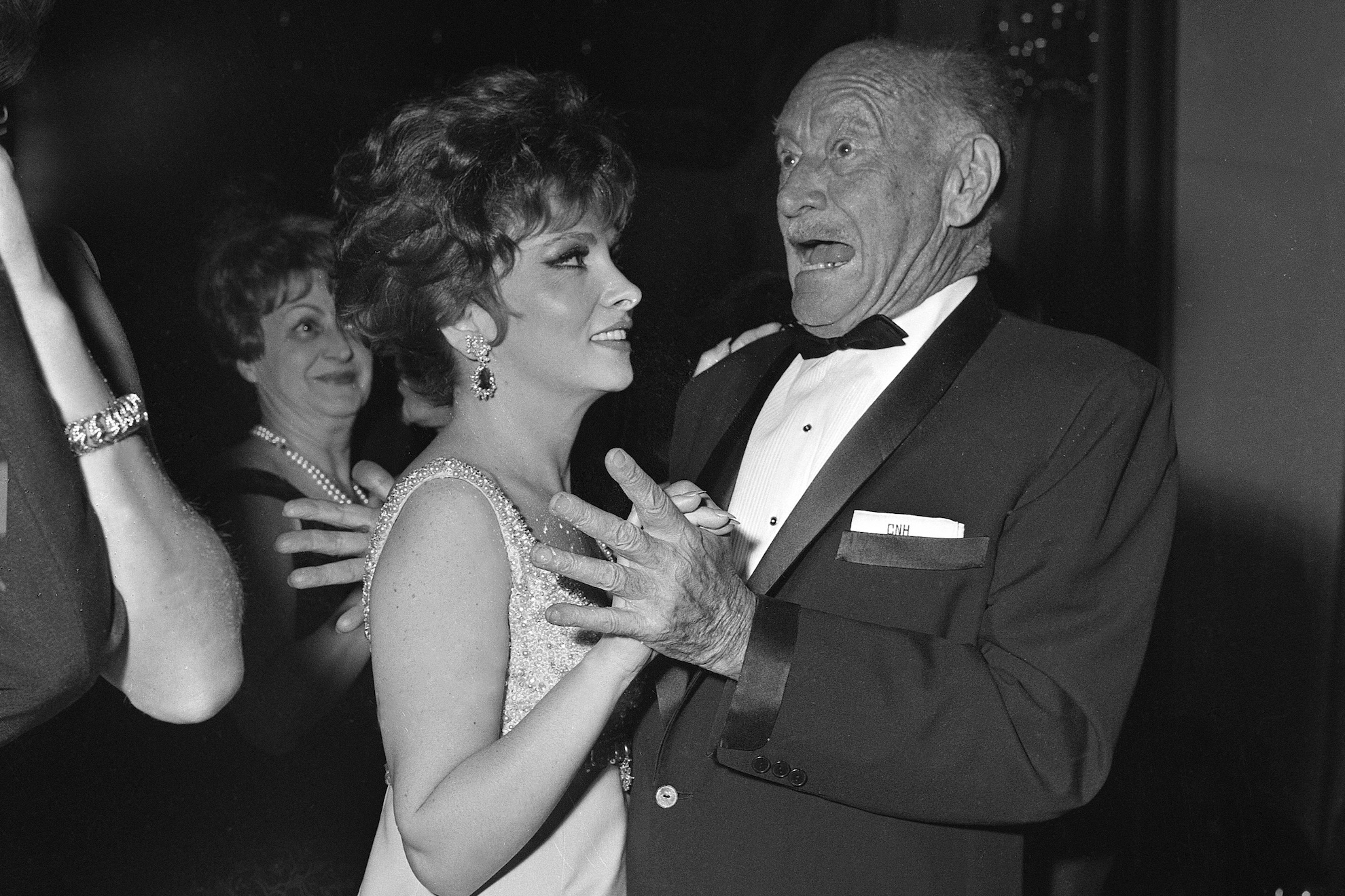 International hotel magnate Conrad Hilton reacts to something other than his dance partner, actress Gina Lollobrigida, during the gala opening of his new Hilton Hotel in Paris, April 23, 1966 LAPRESSE