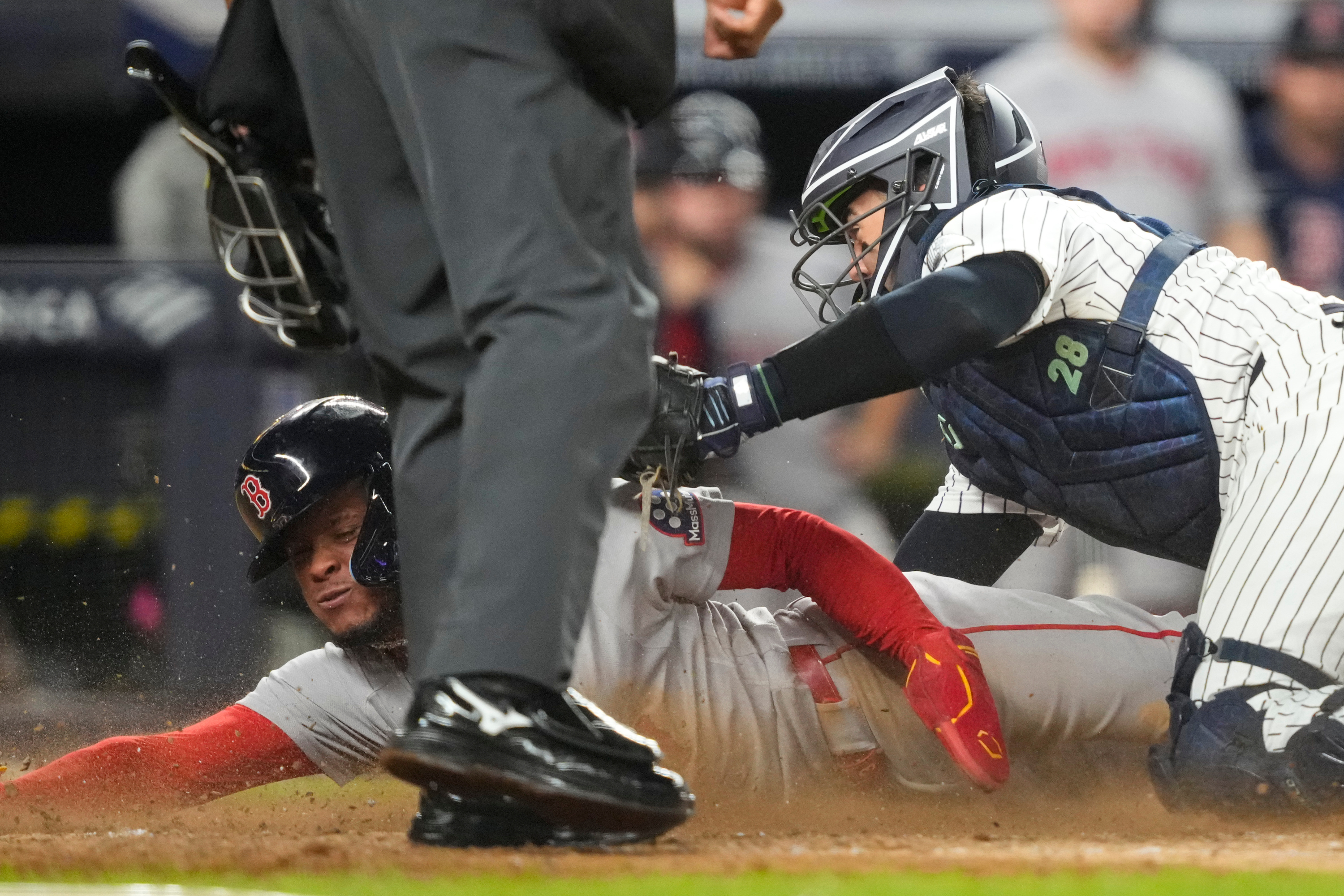 Boston Red Sox' Ceddanne Rafaela is tagged out by New York Yankees catcher Austin Wells at home plate on a double play during the seventh inning of a baseball game, Friday, Aug. 28, 2026, in New York. (AP Photo/Yuki Iwamura) Yuki Iwamura