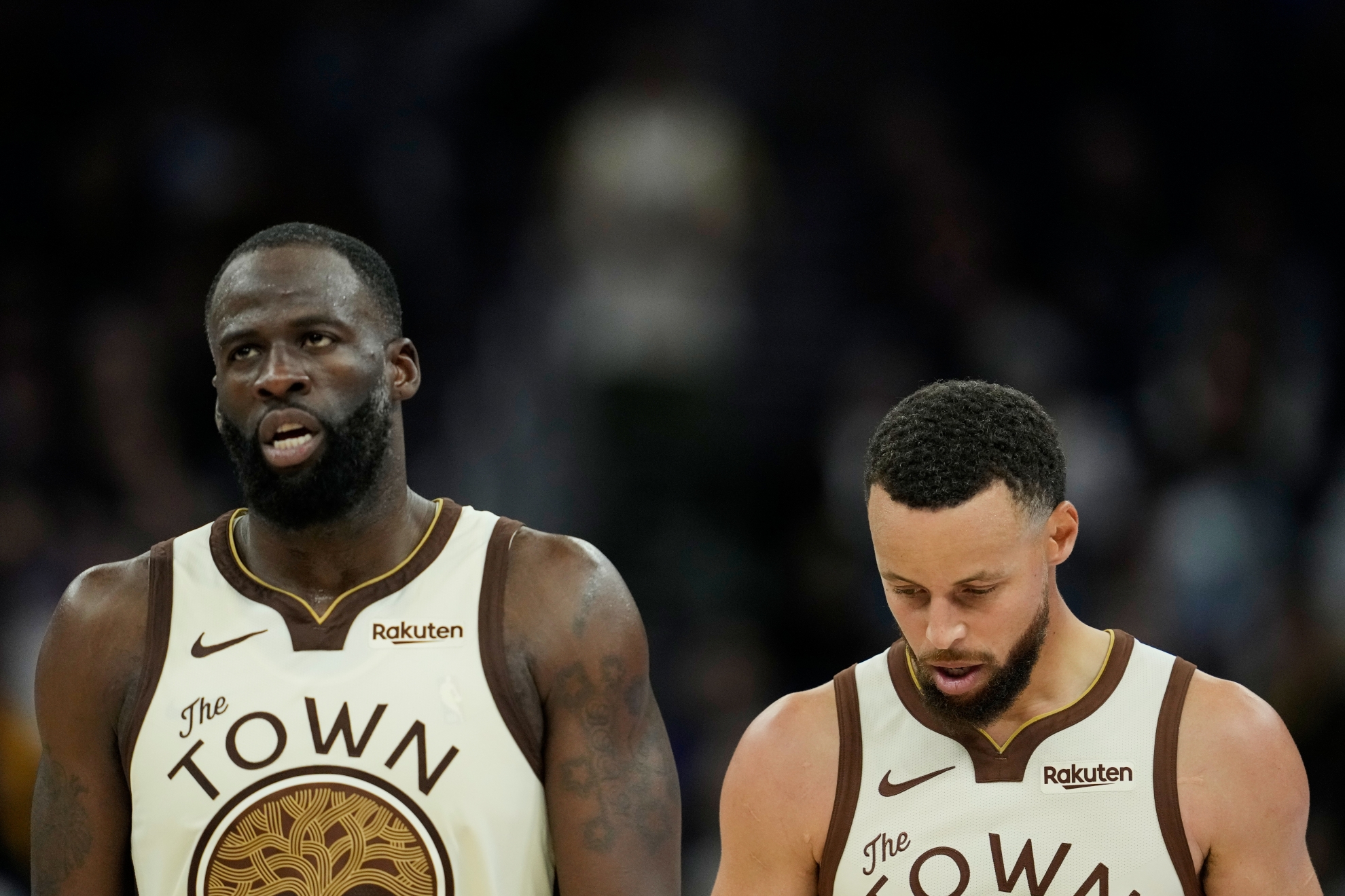 Golden State Warriors forward Draymond Green, left, and guard Stephen Curry walk on the court