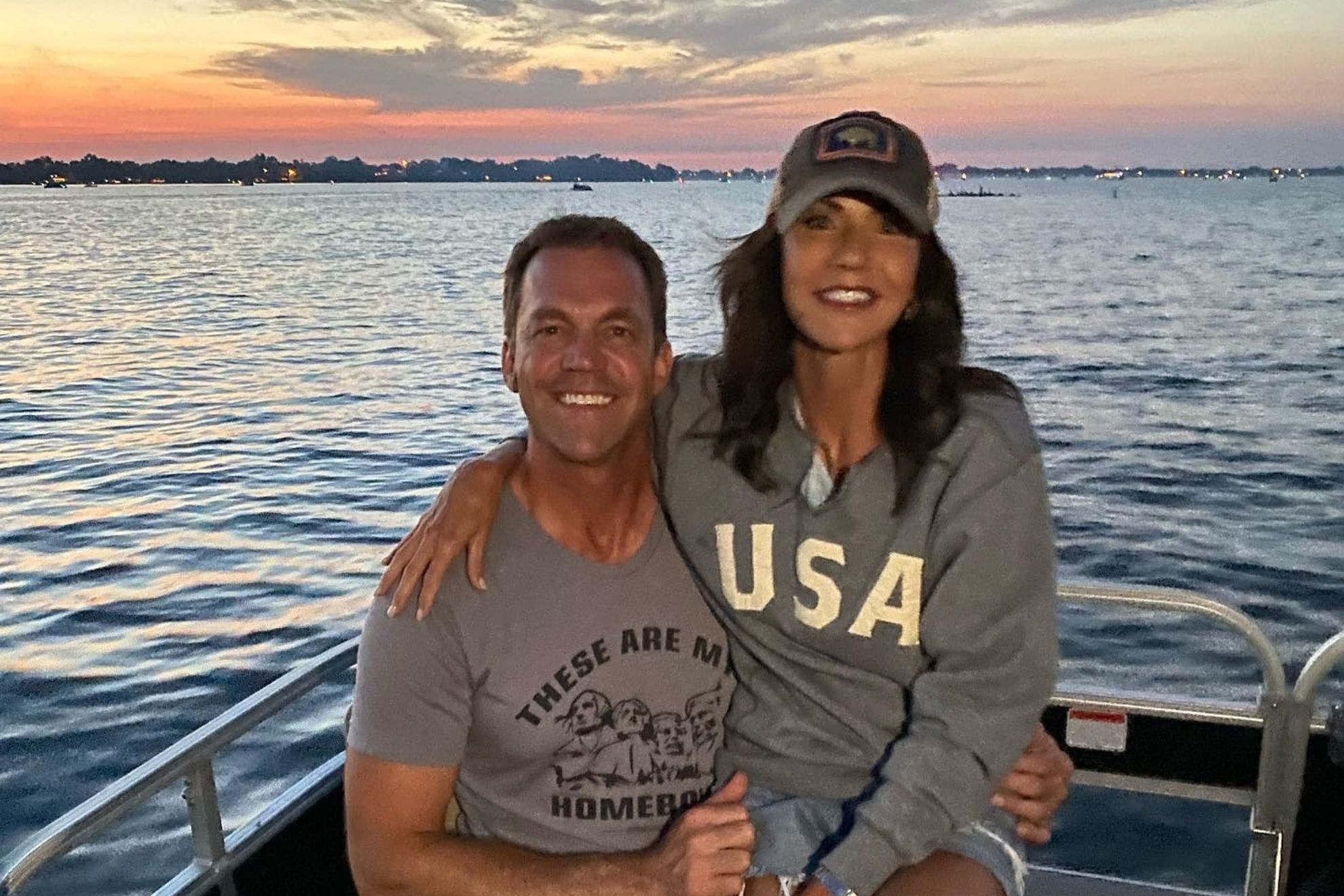 Kristi Noem and Bryon Noem embrace and smile together