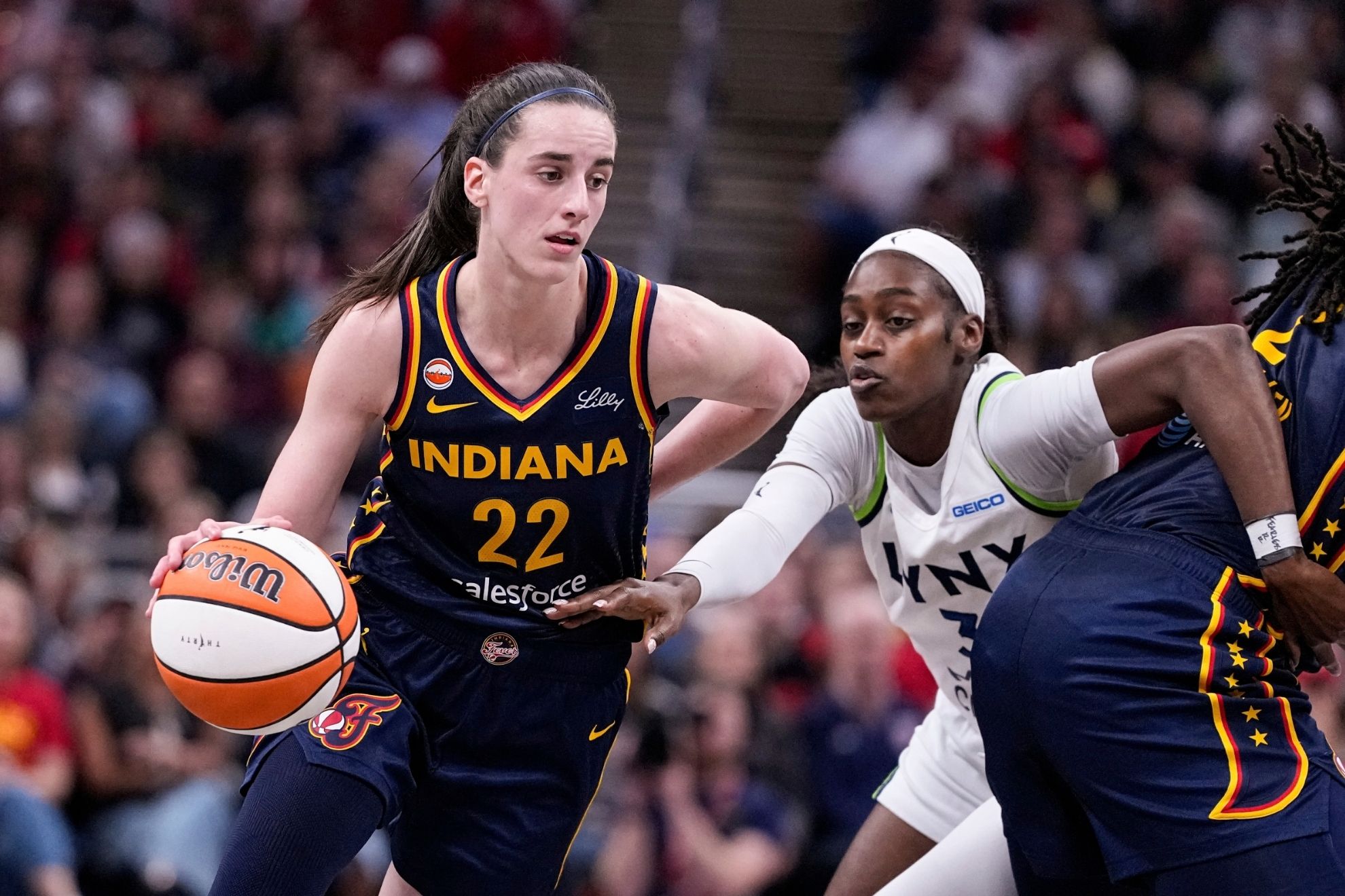 Indiana Fever guard Caitlin Clark drives past Minnesota Lynx guard Maya Caldwell AP
