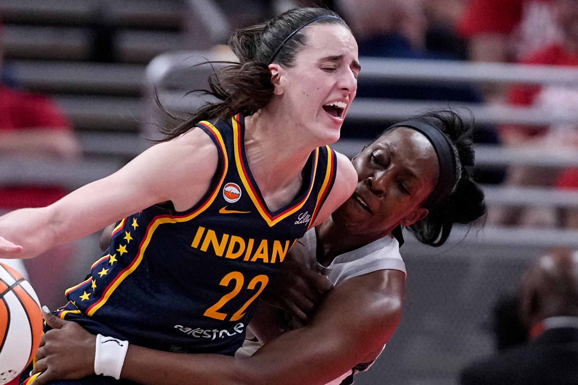 Las Vegas Aces guard Chelsea Gray, right, defends Indiana Fever guard Caitlin Clark (22)
