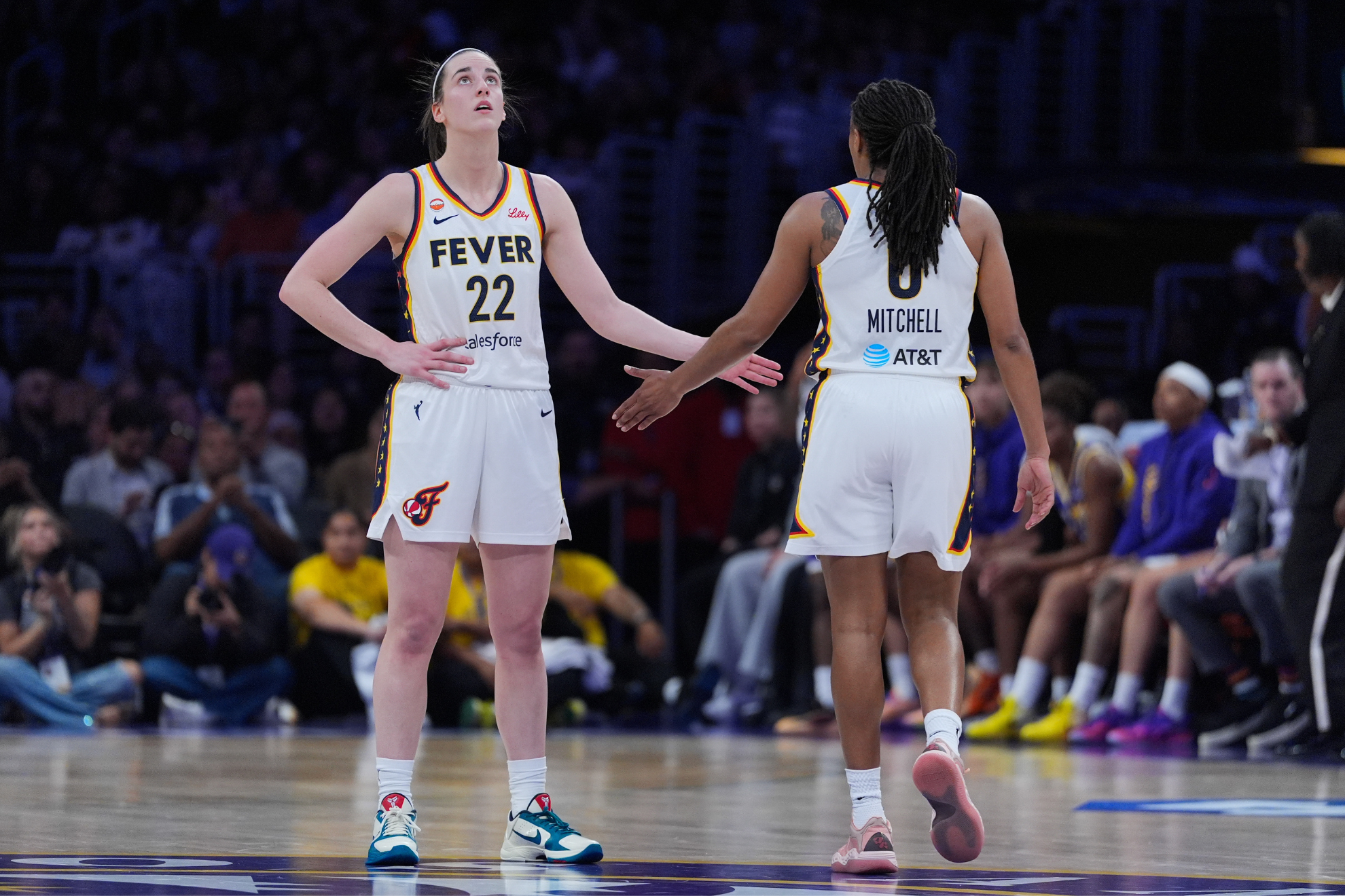 Indiana Fever guard Caitlin Clark (22) and guard Kelsey Mitchell (0) react to a play
