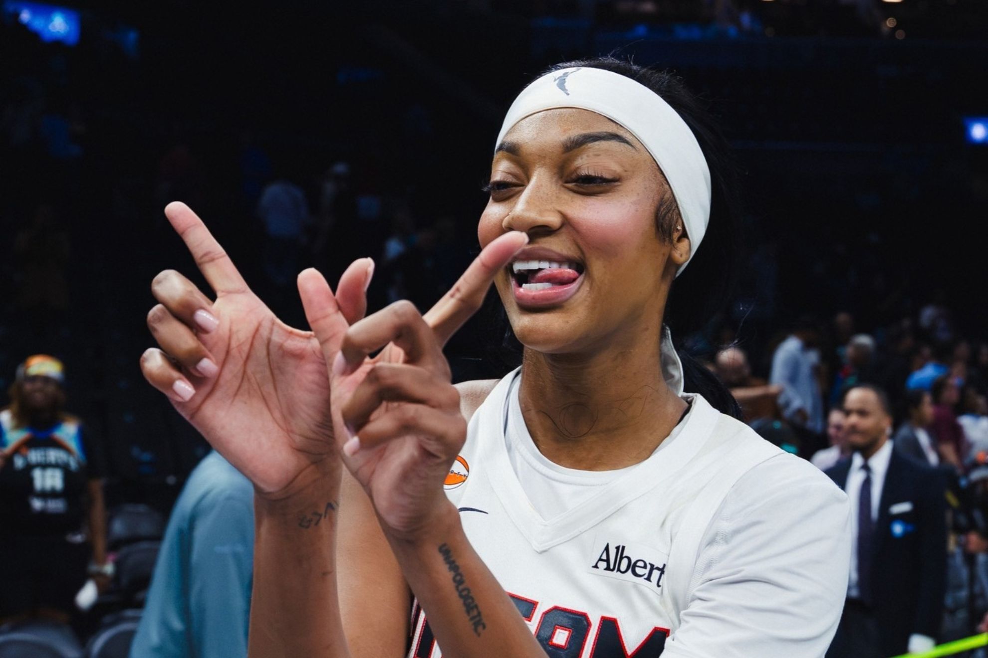 Angel Reese celebrates on the court