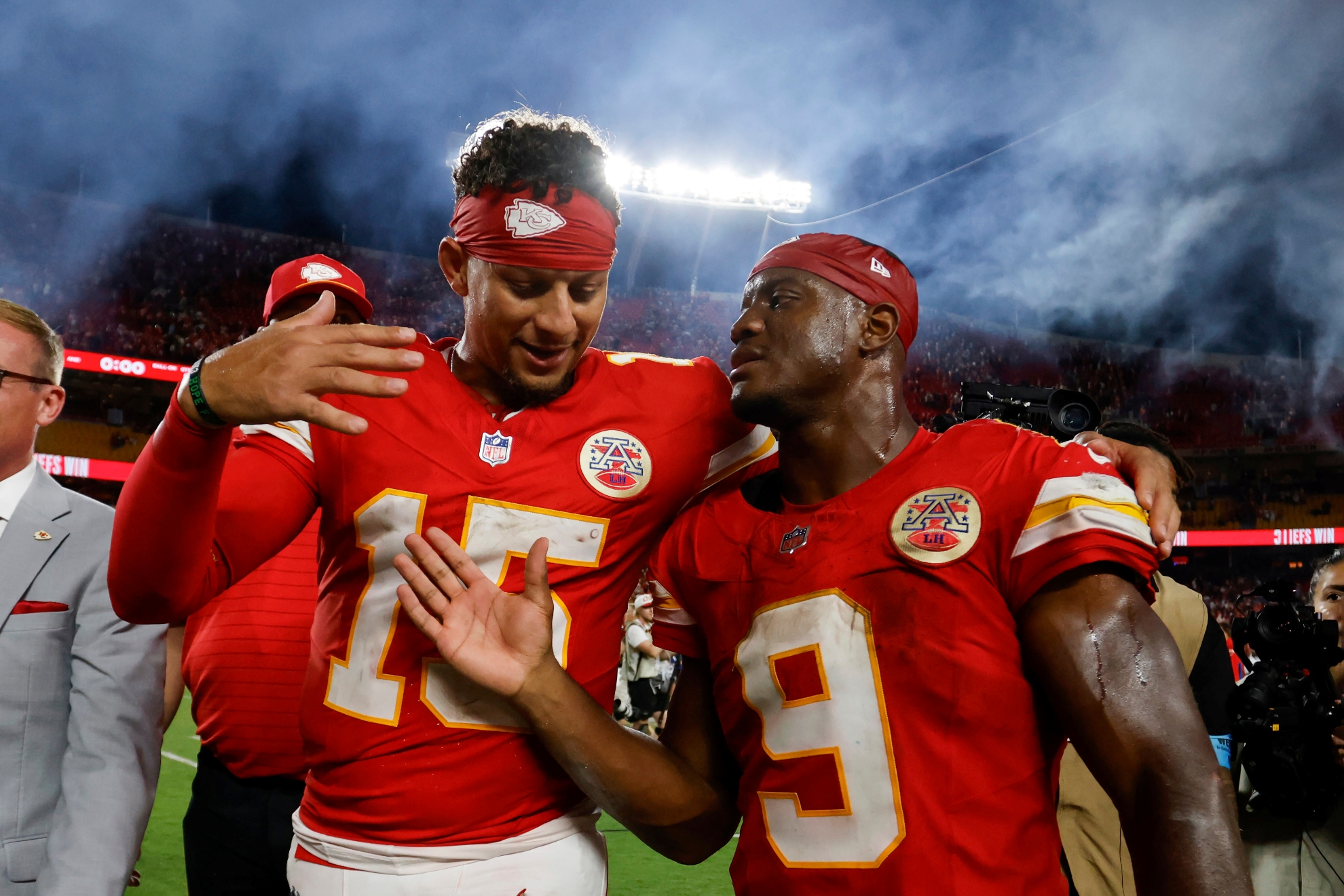 Kansas City Chiefs quarterback Patrick Mahomes (15) and running back Kenneth Walker III (9) walk off the field