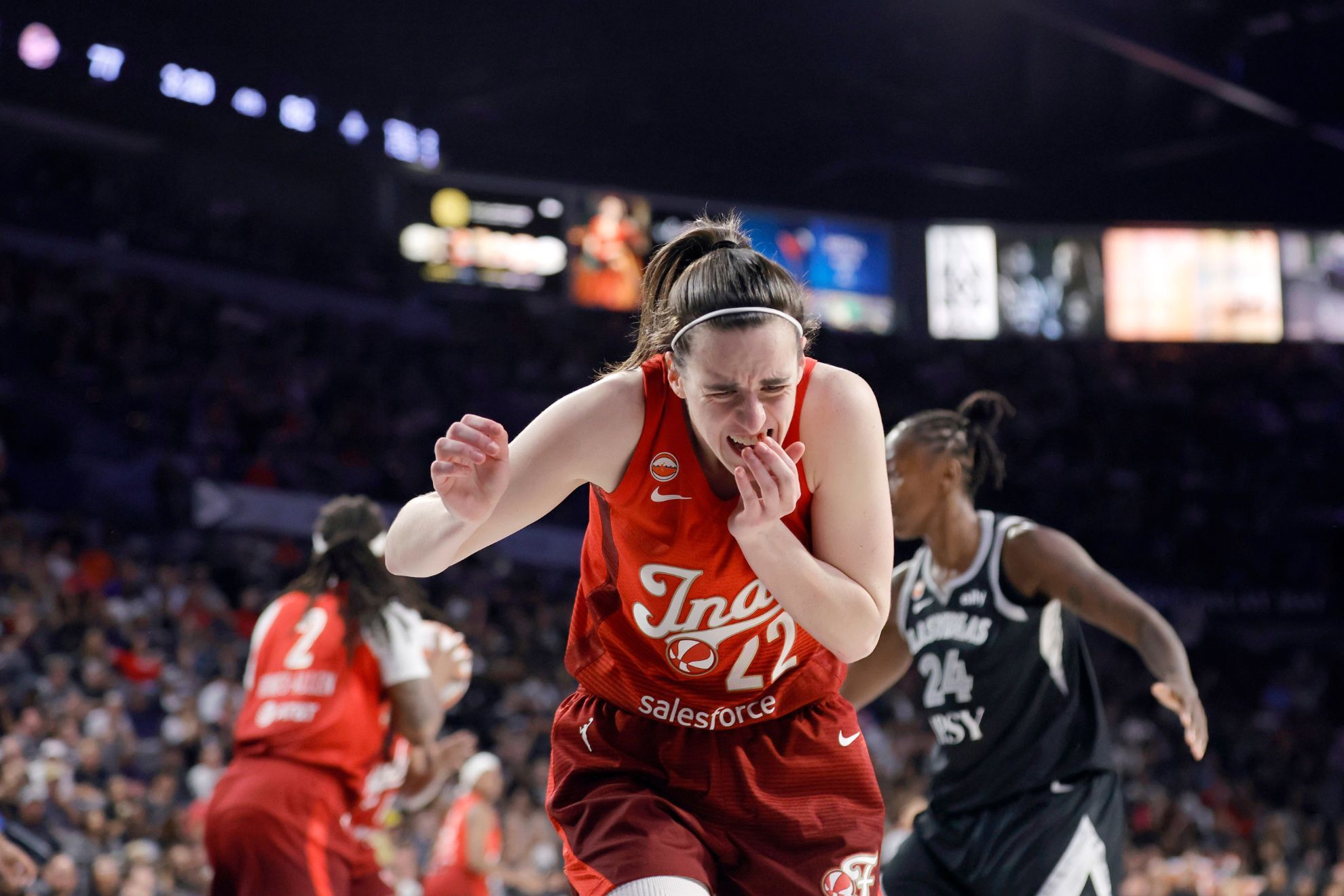 Indiana Fever guard Caitlin Clark (22) reacts after being hit during the second half in Game 3 of an WNBA basketball