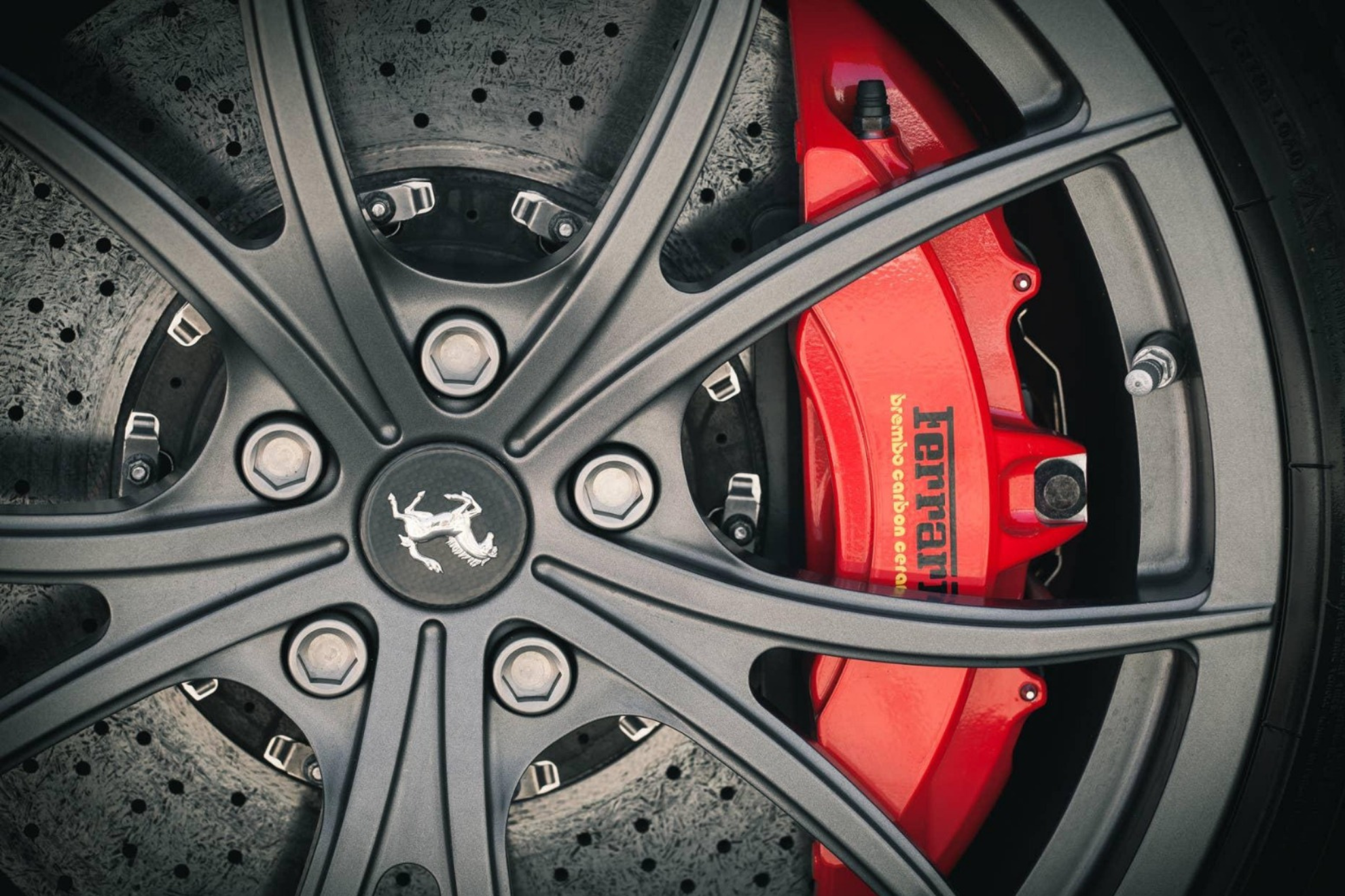 Carbon-ceramic brake discs are one example of racing-derived technology adapted for high-performance road cars.