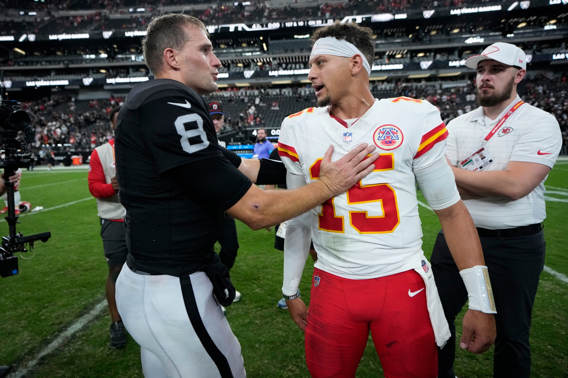 Las Vegas Raiders quarterback Kirk Cousins (8) and Kansas City Chiefs quarterback Patrick Mahomes (15) talk on the field after an NFLgame in Las Vegas.