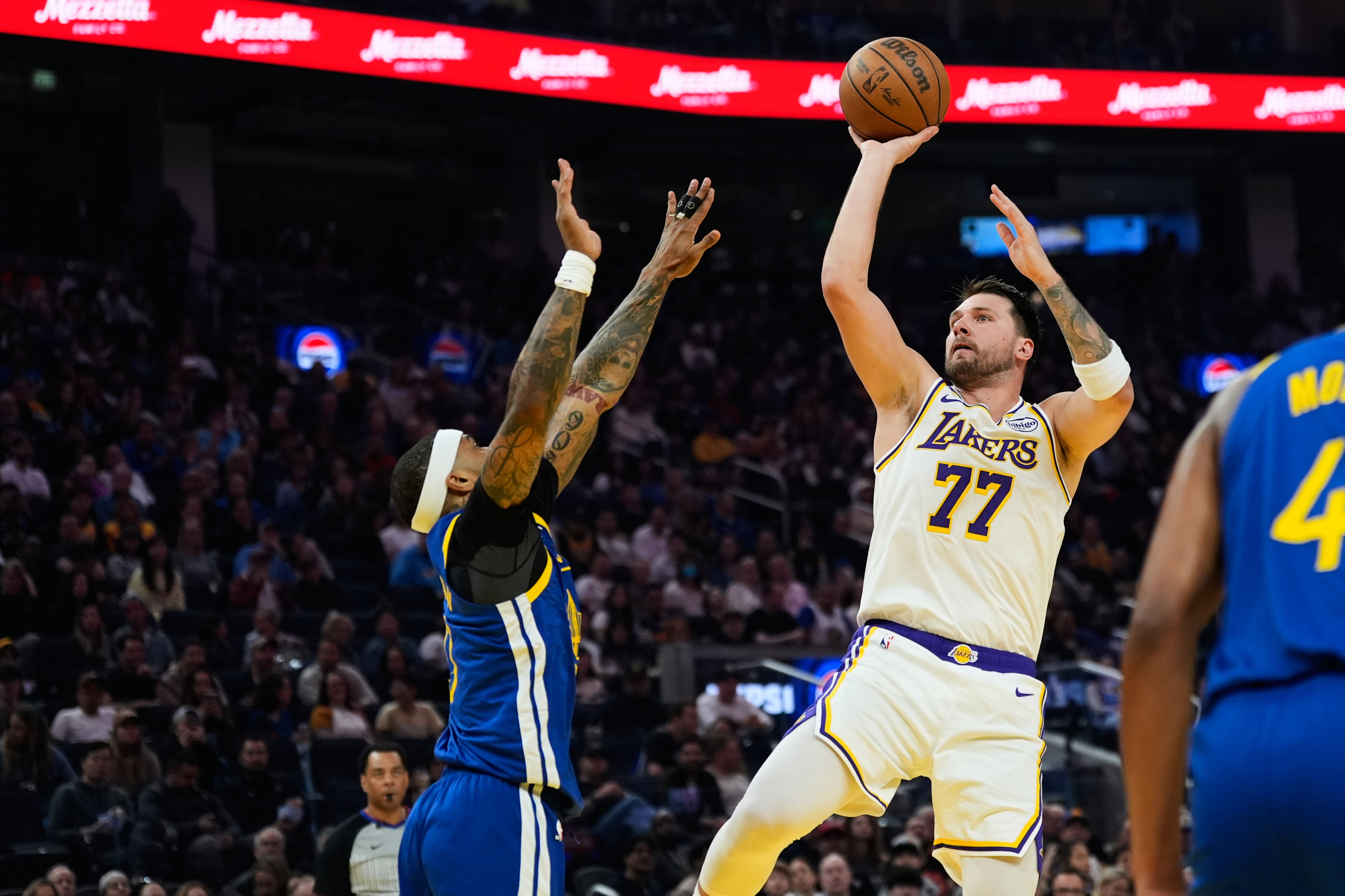 Los Angeles Lakers guard Luka Doncic (77) shoots over Golden State Warriors guard Gary Payton II (0) during the first half of an NBA basketball game, Saturday, Feb. 28, 2026, in San Francisco. (AP Photo/Godofredo A. Vásquez) Godofredo A. Vásquez