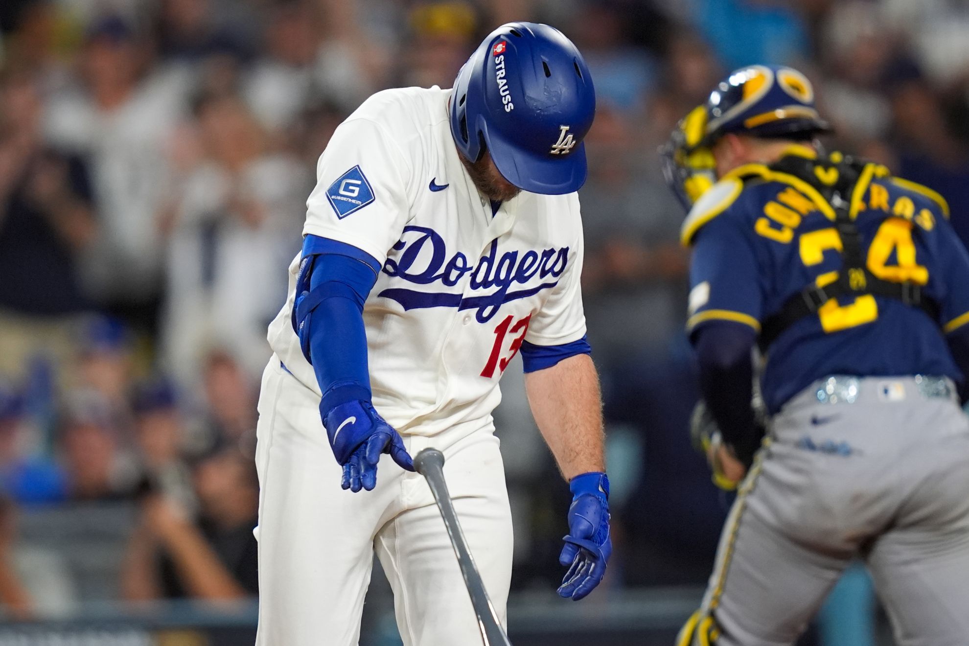 Los Angeles Dodgers third baseman Max Muncy (13) slams his bat after striking out