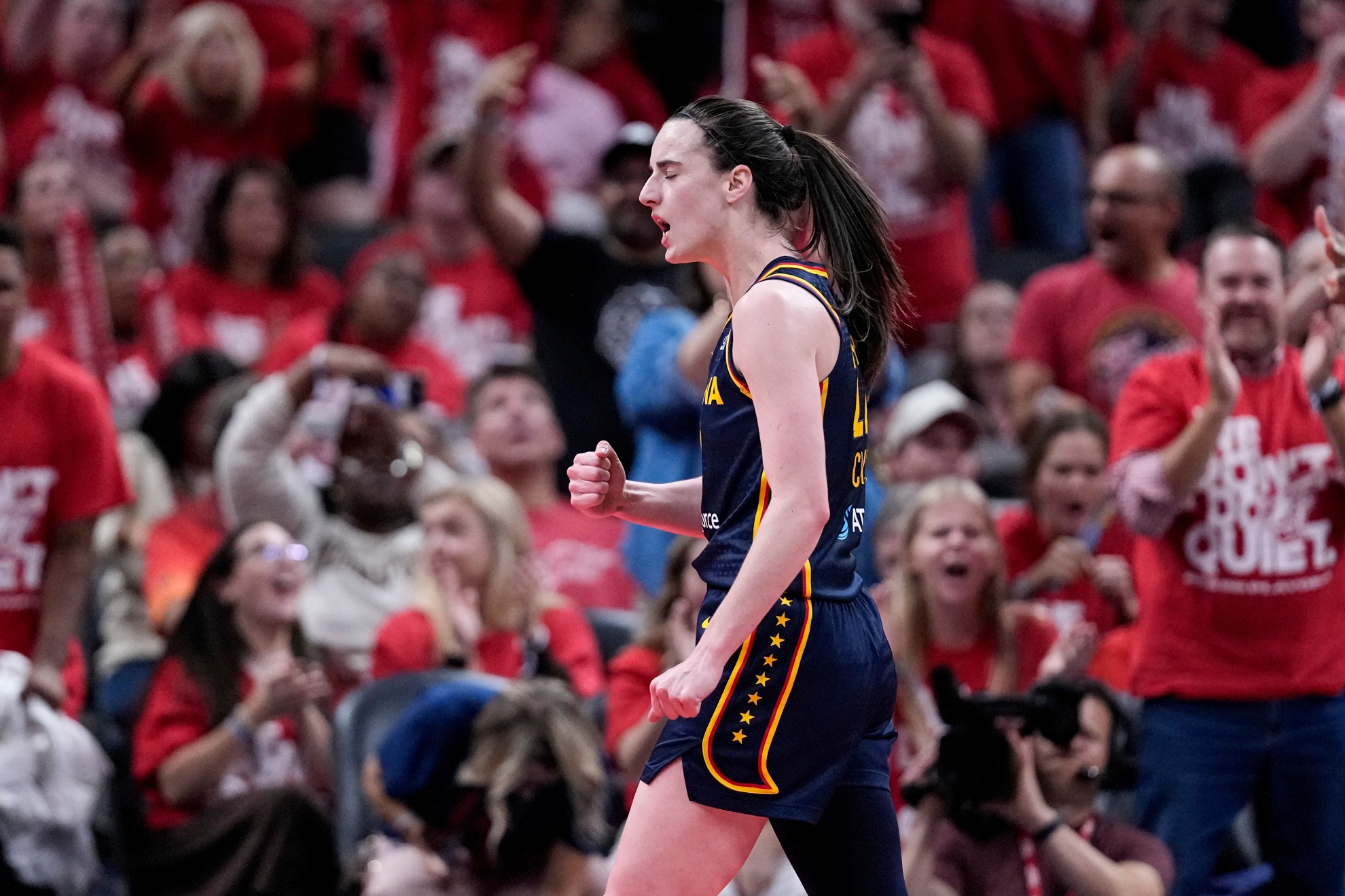 Indiana Fever guard Caitlin Clark celebrates a three-point basket against the Las Vegas Aces