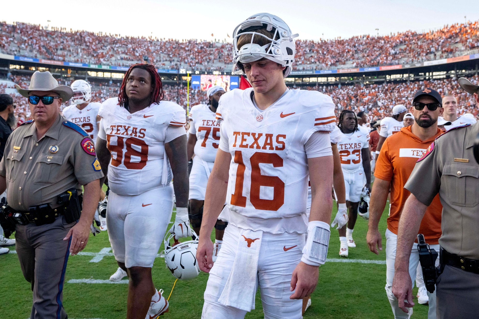 Texas quarterback Arch Manning walks off the field after losing to Oklahoma in an NCAA college football game