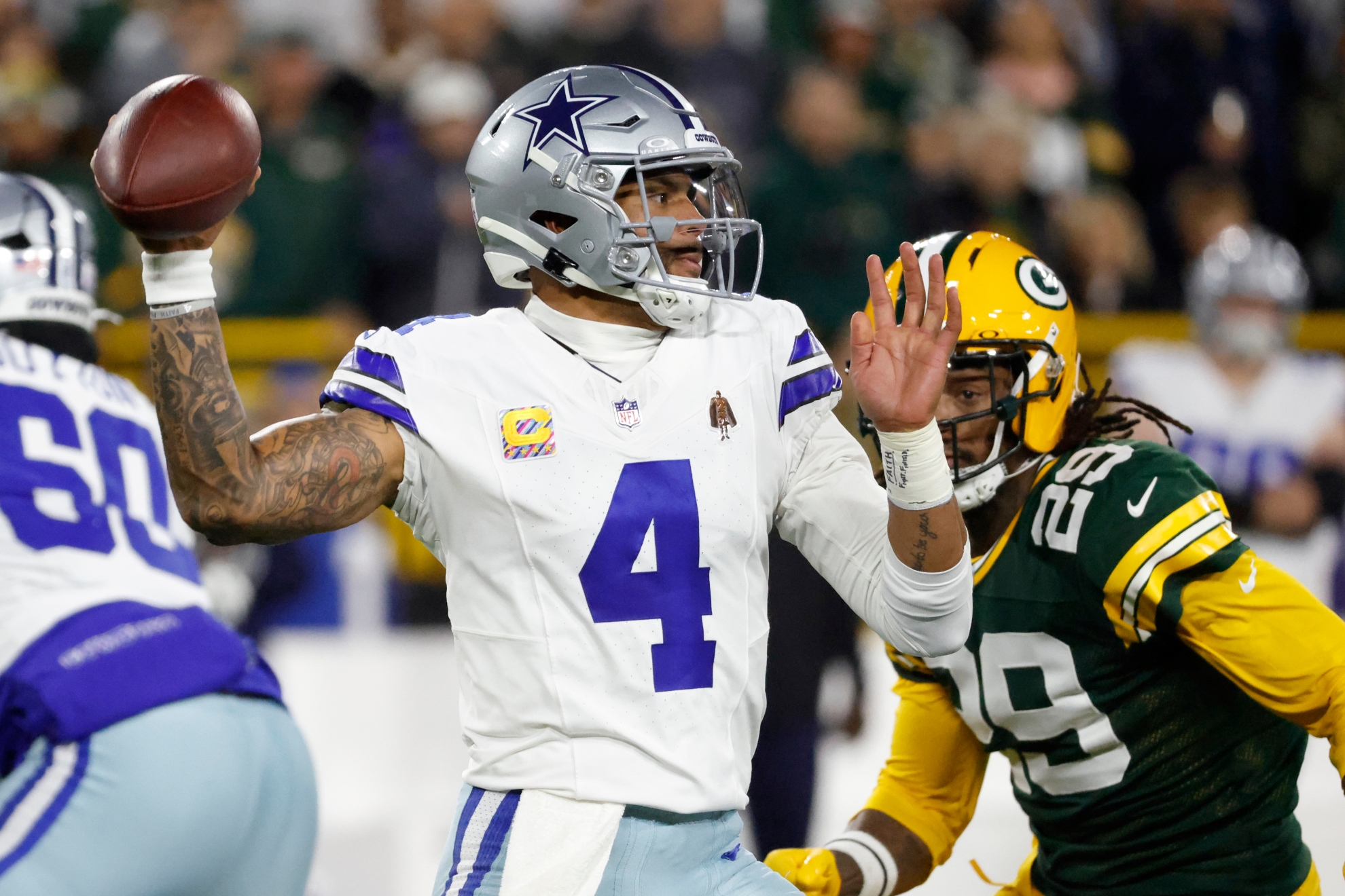 Dallas Cowboys' Dak Prescott throws during the first half of an NFL football game against the Green Bay Packers