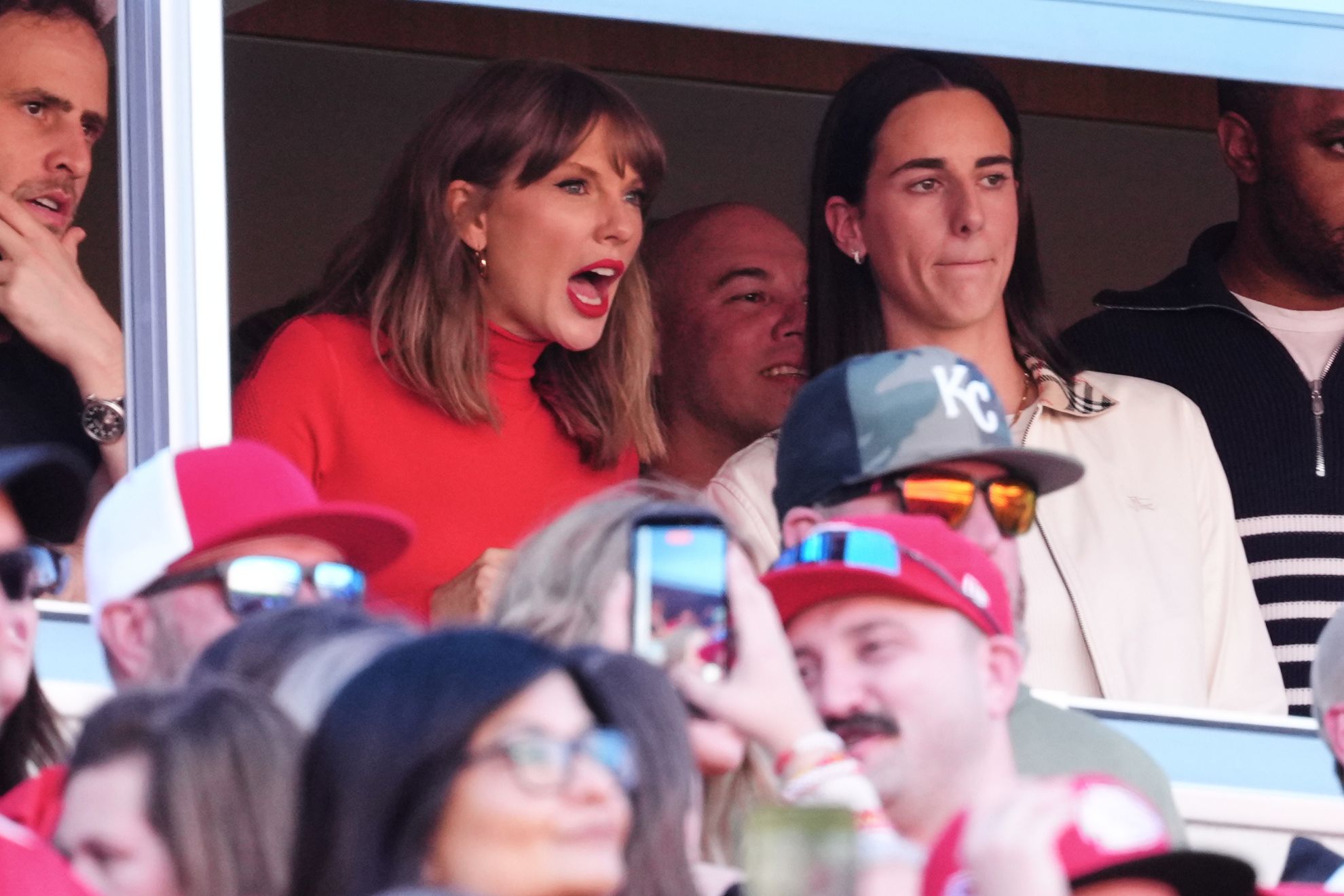 Taylor Swift, center left, and WNBA player Caitlin Clark, center right, watch play between the Los Angeles Chargers and Kansas City Chiefs