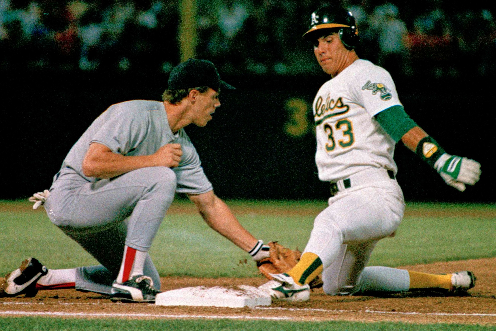 Oakland Athletics' Jose Canseco is almost off picked off by Boston Red Sox Todd Benzinger /