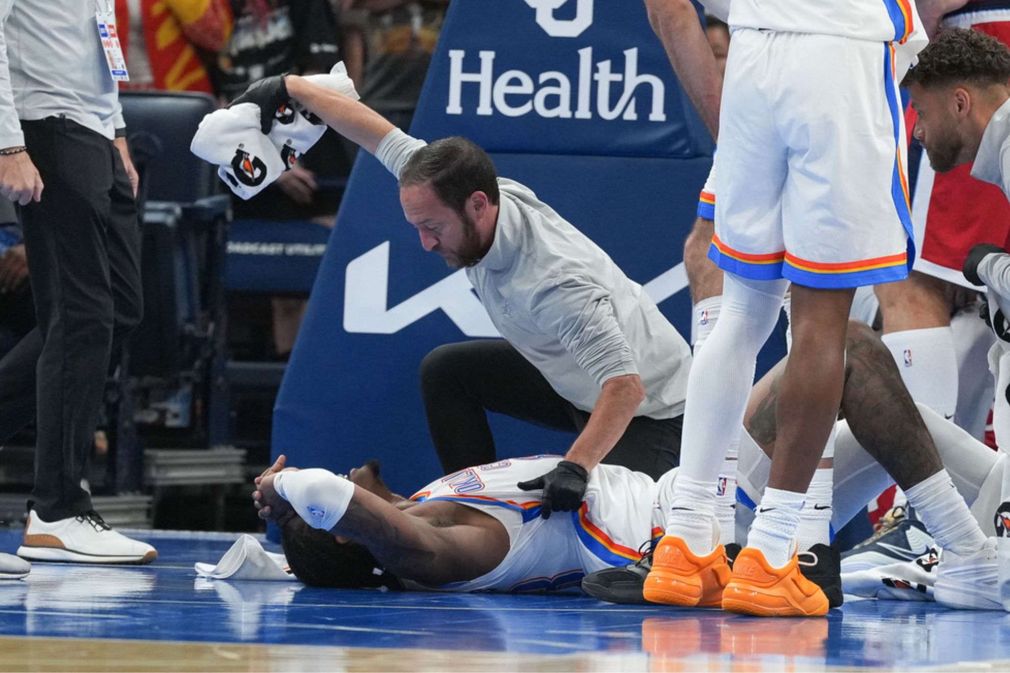 Oklahoma City Thunder guard Jalen Williams is attended to by medical staff during the second half