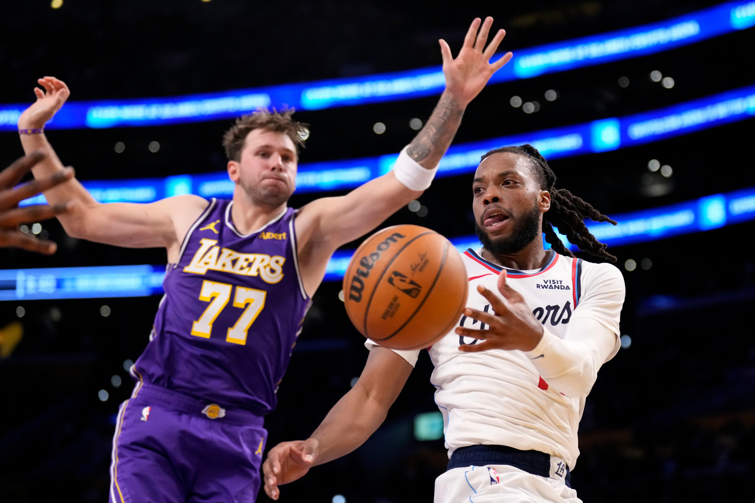 LA Clippers guard Darius Garland, right, passes while under pressure from Los Angeles Lakers guard Luka Doncic during the second half of an NBA basketball game Friday, Oct. 23, 2026, in Los Angeles. (AP Photo/Mark J. Terrill) Mark J. Terrill