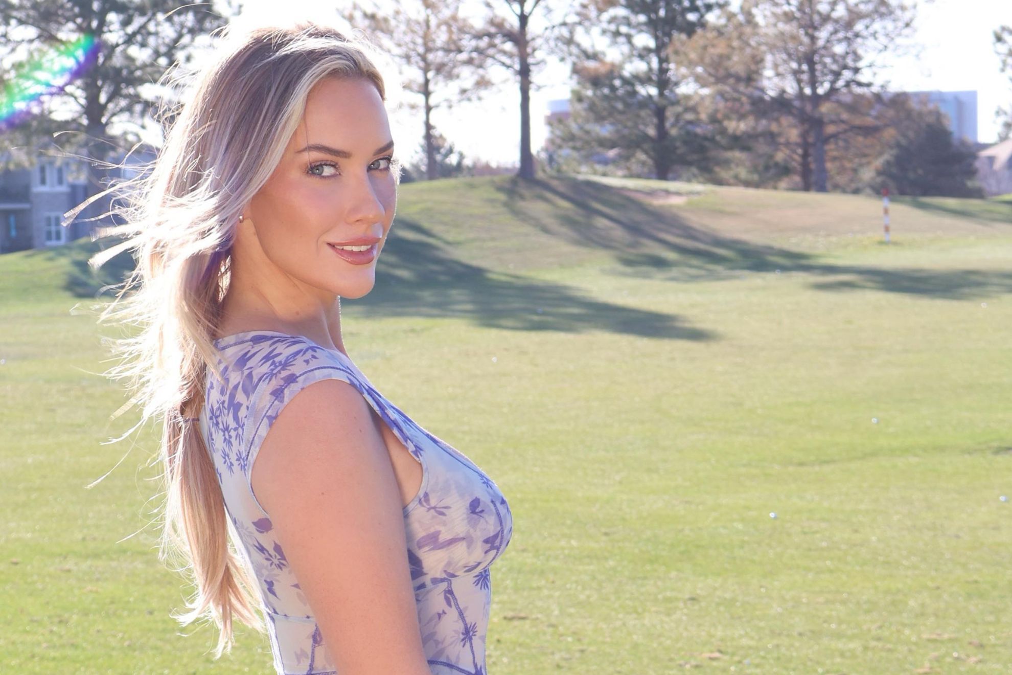 Paige Spiranac poses on the golf course