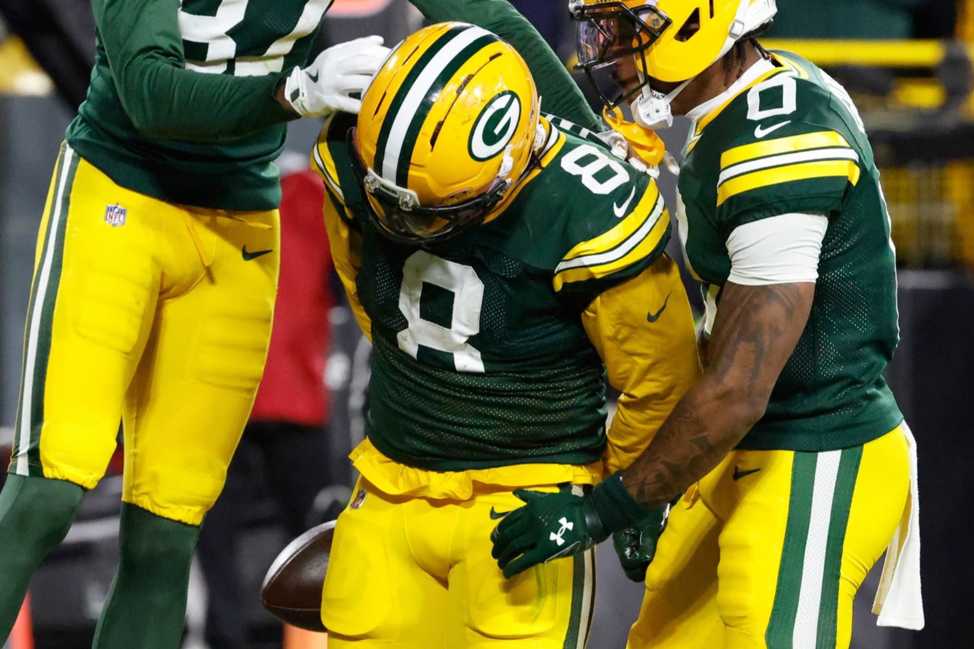 Green Bay Packers running back Josh Jacobs (8) celebrates after scoring a touchdown
