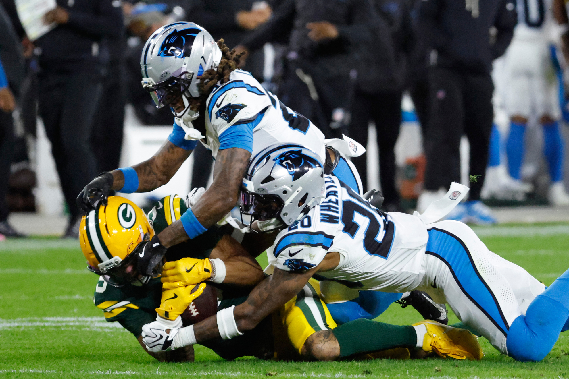 Christian Watson is tackled by Will Lee III and Zakee Wheatley LAPRESSE