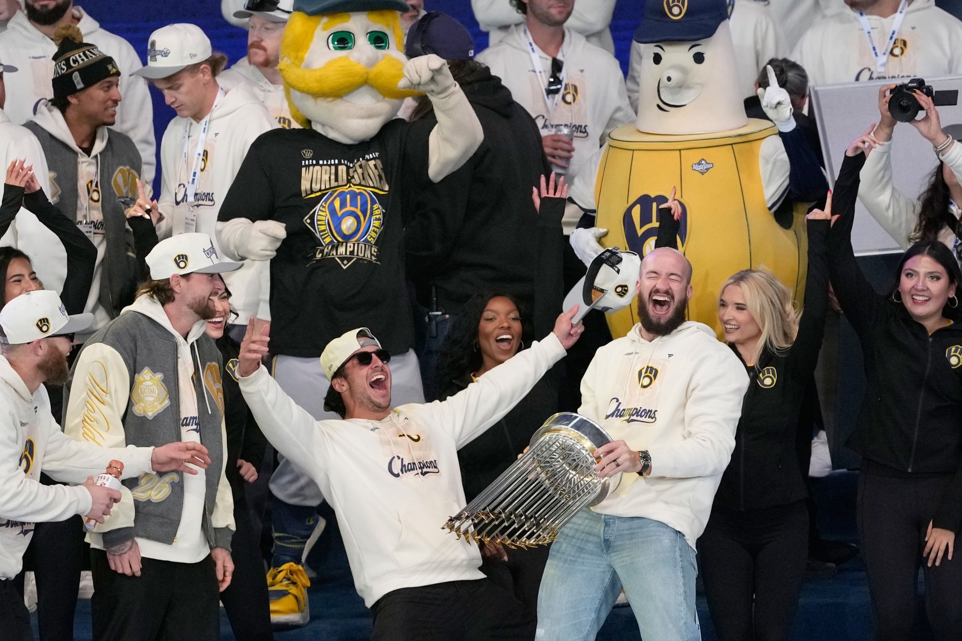 Milwaukee Brewers Aaron Ashby, right, holds up the Commissioner's Trophy as he celebrates with teammates during a rally at the baseball team's World Series Parade, Friday, Oct. 30, 2026, in Milwaukee. AP