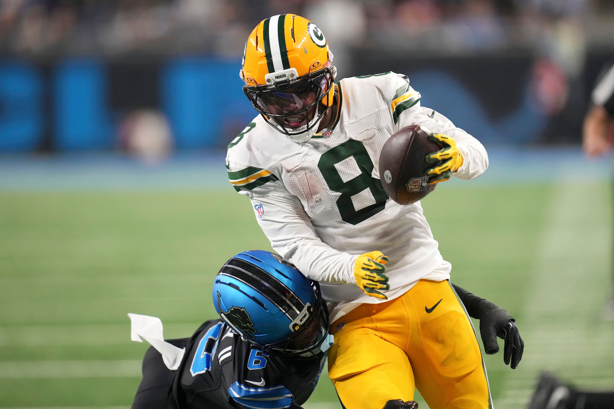 Green Bay Packers running back Josh Jacobs (8) breaks a tackle by Detroit Lions cornerback Keith Abney II (6) during a touchdown reception in the second half of an NFL football game. Paul Sancya